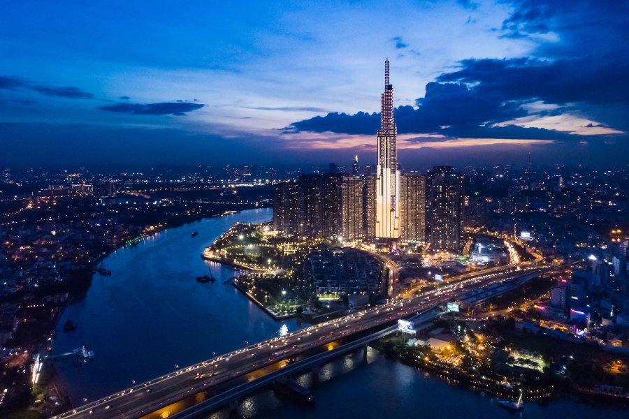Vue panoramique de la skyline de Ho Chi Minh Ville au crépuscule, avec des gratte-ciel modernes et le fleuve Saigon scintillant.